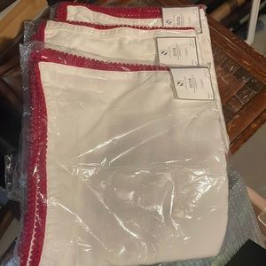 White napkins with Red ball trim, 20 by 20, 3 sets of 4, packages never opened.